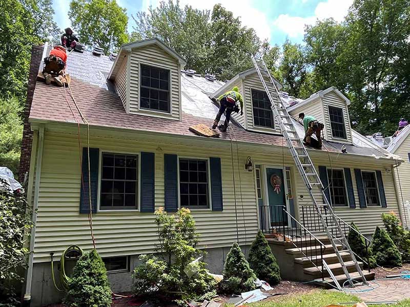 South County Exteriors workers installing new shingles on a residential roof